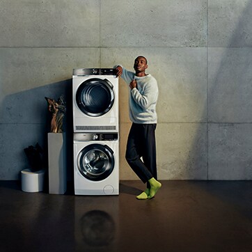 Man standing next to washing machines