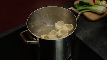 Boiling pasta in a pot on a hob